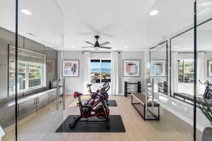 Exercise room with recessed lighting, light wood-style flooring, and ceiling fan