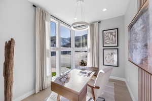 Office space with light wood-style flooring, baseboards, and a wealth of natural light