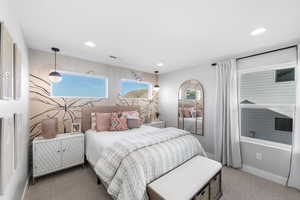 Carpeted bedroom featuring visible vents, baseboards, and recessed lighting