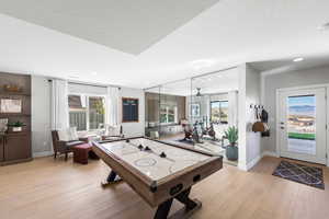 Playroom featuring light wood-style floors, baseboards, and recessed lighting