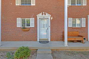 View of exterior entry with brick siding