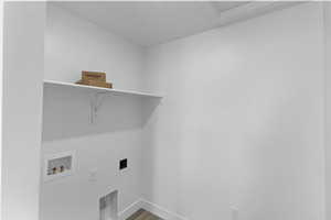 Laundry room with hookup for an electric dryer, baseboards, hookup for a washing machine, wood finished floors, and laundry area