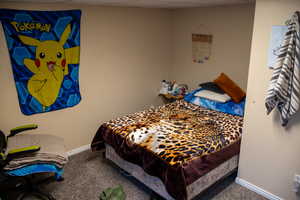 Bedroom featuring carpet floors and baseboards