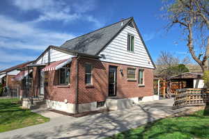 View of home's exterior featuring brick siding and roof with shingles