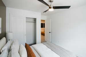 Bedroom with a closet, baseboards, a ceiling fan, and carpet floors