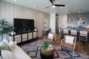 Living area with a ceiling fan, recessed lighting, and dark wood finished floors