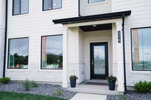 Doorway to property with brick siding