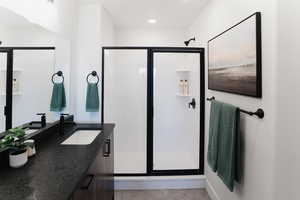 Full bath with a shower stall, recessed lighting, and vanity