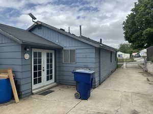 Rear view of property featuring french doors and fence