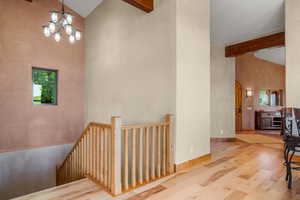 Interior space featuring solid wood beamed high vaulted ceiling, and hickory flooring.
