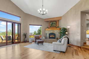 Living area with a towering ceiling, a stone, wood burning fireplace, radiant heated floors, hydroponic solar system that can reduce propane use upto 50%.