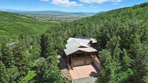 View of subject property featuring a heavily wooded area and mountains