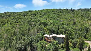 View of subject property with a heavily wooded area