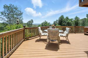 Wooden deck featuring outdoor dining area