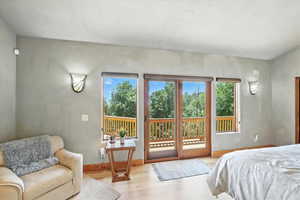 Bedroom with access to outside and wood finished floors