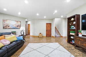 Living room featuring stairs and recessed lighting