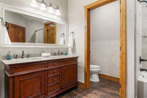 Bathroom with a  double vanity, and wood moulding  and water resistant floors.