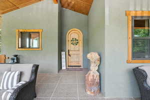 Doorway to property featuring stucco siding