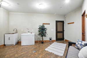 Washroom with baseboards and cabinet space