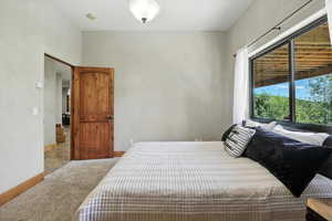 Carpeted bedroom with baseboards