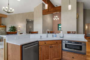 Stainless steel appliances including a Bosh gas oven, gas stove, lg fridge, energy cert dishwasher, and a farm sink.