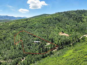 Aerial view of property and surrounding area featuring property boundaries highlighted