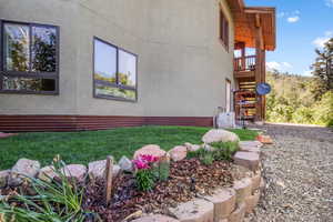 View of home's exterior featuring flower beds and walk ways