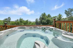 View of swimming pool with an outdoor hot tub