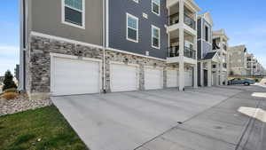 Exterior space featuring a garage, a residential view, and driveway