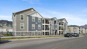 View of building exterior featuring a residential view and fence