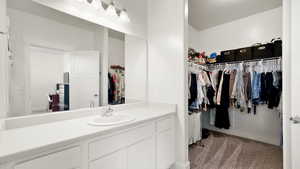 Bathroom with a spacious closet and vanity