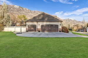 View of side of home featuring a mountain view, stucco siding, and stone siding