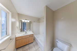Master Bathroom with toilet, vanity, shower / tub combination, and tile flooring
