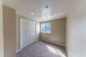 Bedroom 4 featuring a closet, baseboards, carpeted floors.