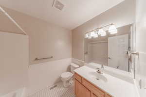 Full upstairs bath with wainscoting, and vanity