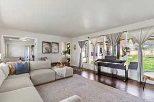 Living area with large windows featuring courtyard view.