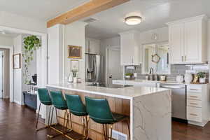 Open Kitchen with Quartz countertops, beautiful solid oak beam and planks  the under bar