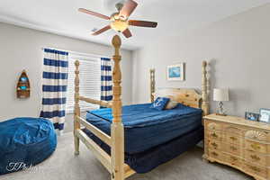 Carpeted bedroom featuring visible vents, baseboards, and a ceiling fan