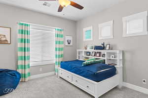 Bedroom with carpet flooring, visible vents, and baseboards