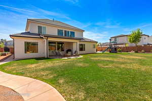 Back of house with a playground, a patio area, and fence