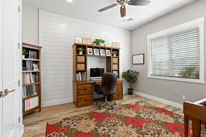Office area with visible vents, baseboards, a ceiling fan, and wood finished floors