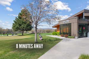 View of property's community featuring a mountain view and a yard