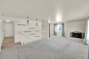 Unfurnished living room featuring carpet and a fireplace