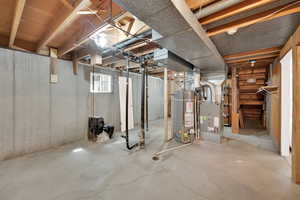 Basement featuring heating unit and gas water heater