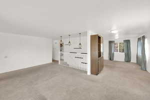 Additional living space with light carpet