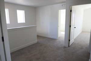 Unfurnished room with baseboards, carpet, and visible vents