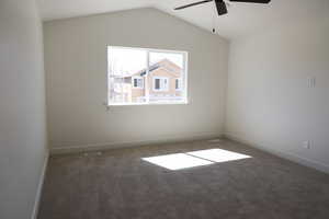 Empty room with visible vents, ceiling fan, carpet, and baseboards