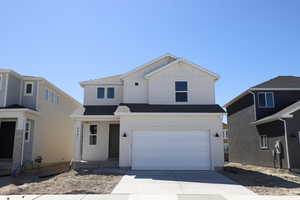 Traditional home with an attached garage, roof with shingles, board and batten siding, and driveway