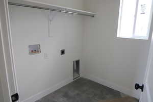 Laundry area featuring hookup for an electric dryer, laundry area, baseboards, and hookup for a washing machine