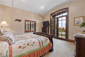 Bedroom with light carpet, access to outside, lofted ceiling, and recessed lighting